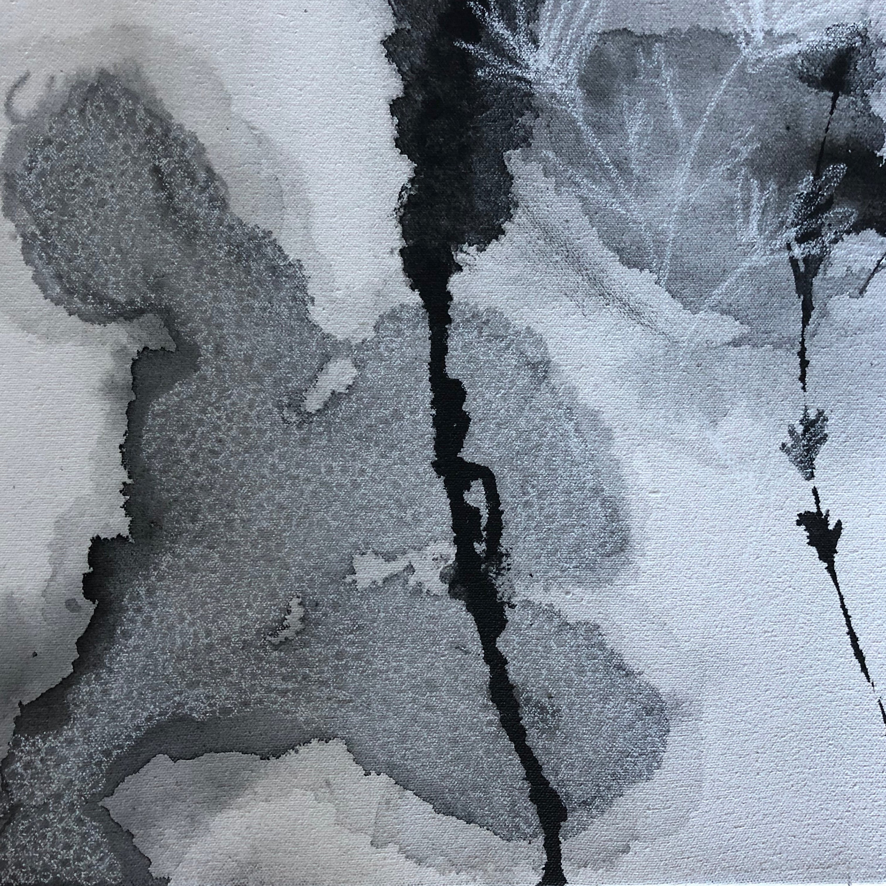 Close-up of abstract black and white artwork on a canvas surface