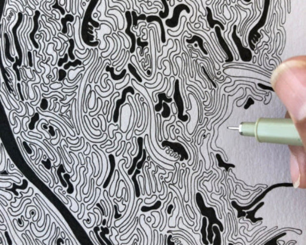 Hand-drawn intricate black and white pattern with a pen on paper